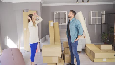 Married-couple-moving-into-their-new-home-placing-items.